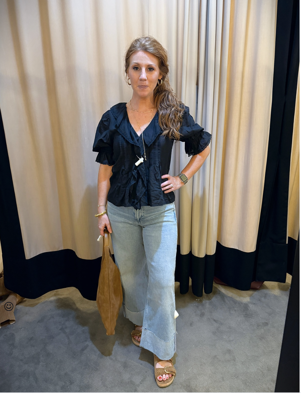Stephanie wearing a black top, and jeans from the Nordstrom Anniversary Sale